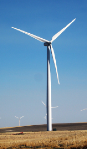 Wind turbine on a Minnesota prairie with blue sky