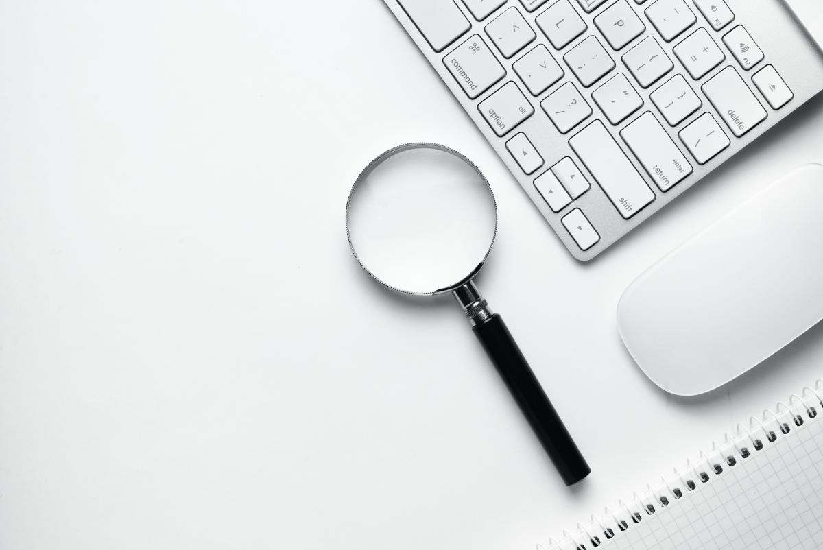 Magnifying glass with keyboard and mouse