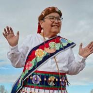 Sharon M. Day dressed in traditional Ojibwe garments. 